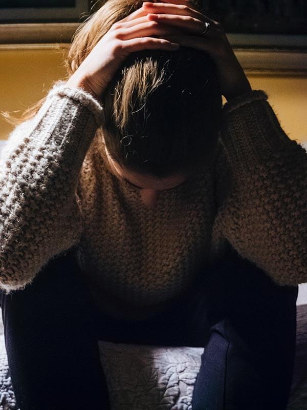 A woman with her hands on her head