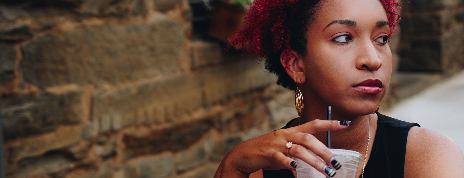 Woman drinking a coffee drink outside